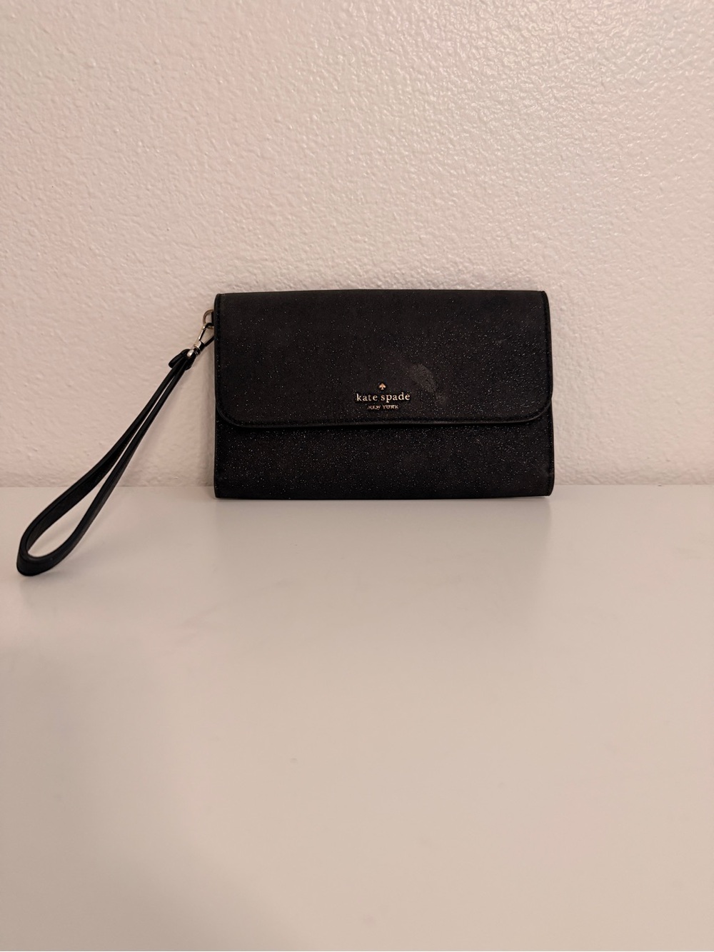kate spade black glitter clutch with gold logo